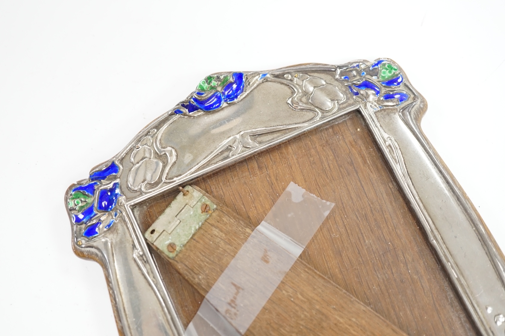 An Edwardian Art Nouveau silver and enamel mounted photograph frame, James Deakin & Sons Ltd, Birmingham, 1902, enamel a.f., 22cm. Condition - poor